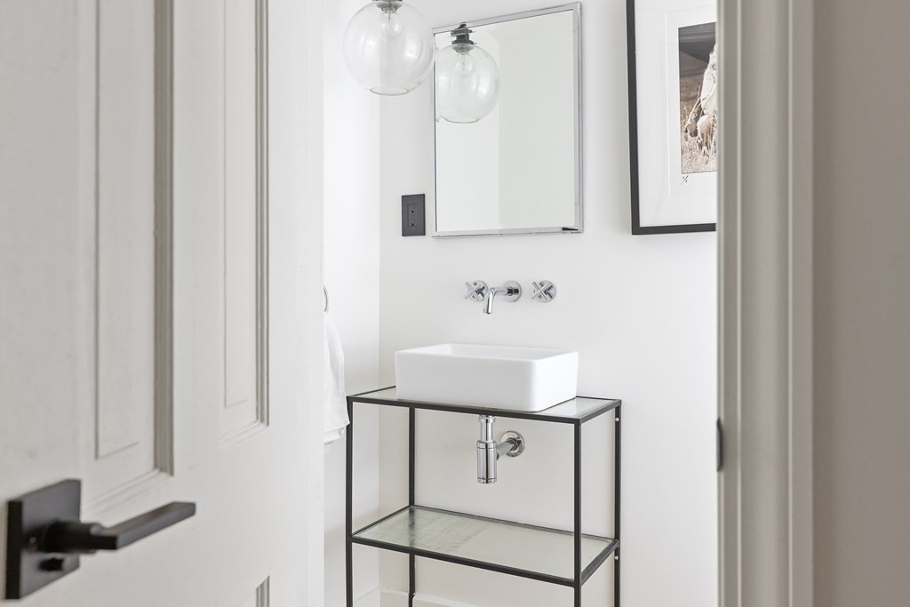 71 Dartmouth Street, Unit 1 Boston, MA 02116 - Photo 13 of 26 a bathroom with a sink a mirror and shower