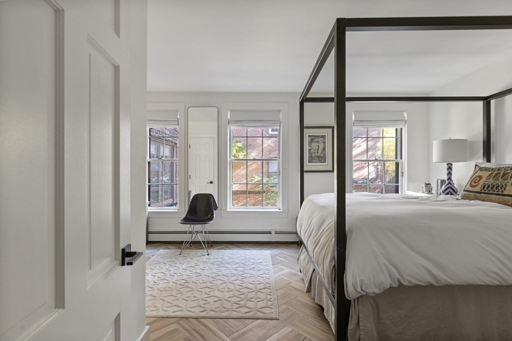71 Dartmouth Street, Unit 1 Boston, MA 02116 - Photo 17 of 26 a living room with a bed furniture and a large window