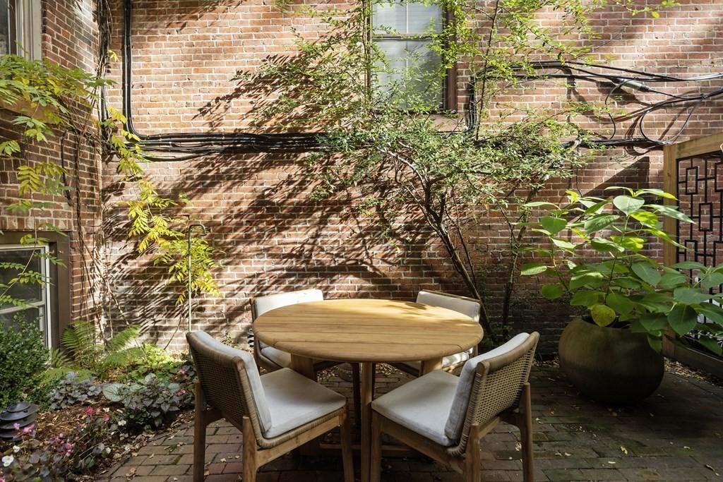 71 Dartmouth Street, Unit 1 Boston, MA 02116 - Photo 21 of 26 a backyard of a house with table and chairs