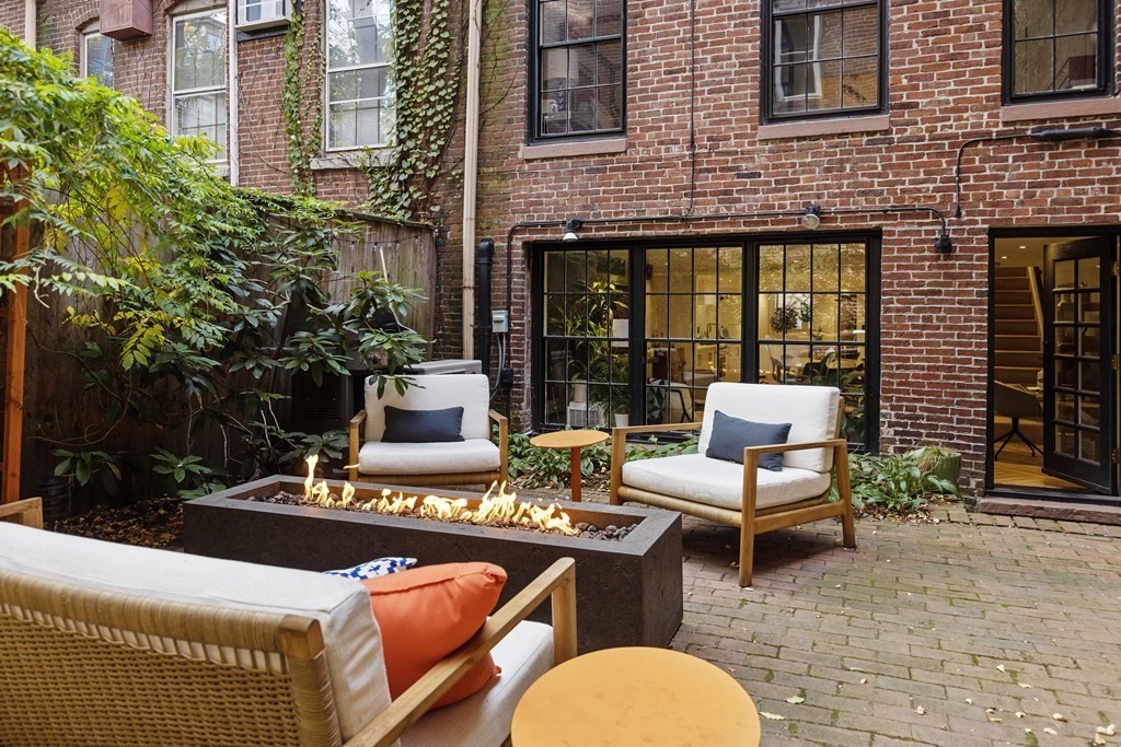 71 Dartmouth Street, Unit 1 Boston, MA 02116 - Photo 24 of 26 a view of a patio with couches table and chairs and potted plants
