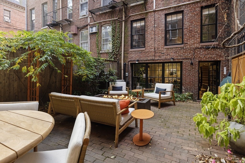 71 Dartmouth Street, Unit 1 Boston, MA 02116 - Photo 25 of 26 a view of a patio with chairs and a table