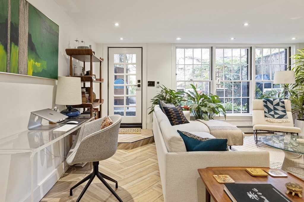 71 Dartmouth Street, Unit 1 Boston, MA 02116 - Photo 3 of 26 a living room with furniture floor to ceiling window and potted plants