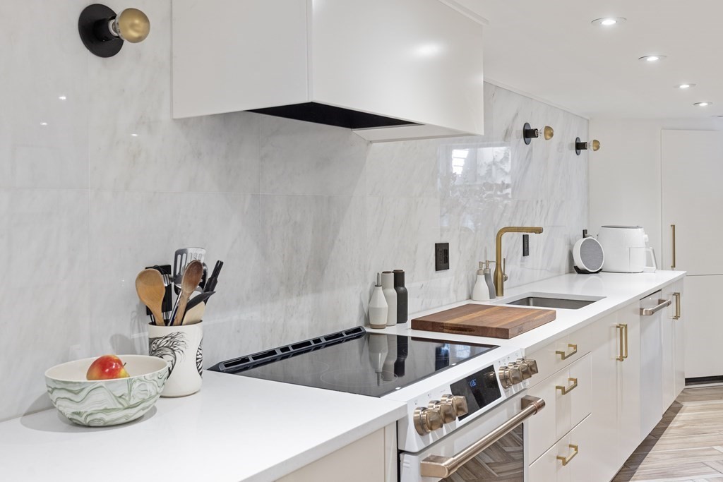 71 Dartmouth Street, Unit 1 Boston, MA 02116 - Photo 9 of 26 a kitchen with a sink a stove and cabinets