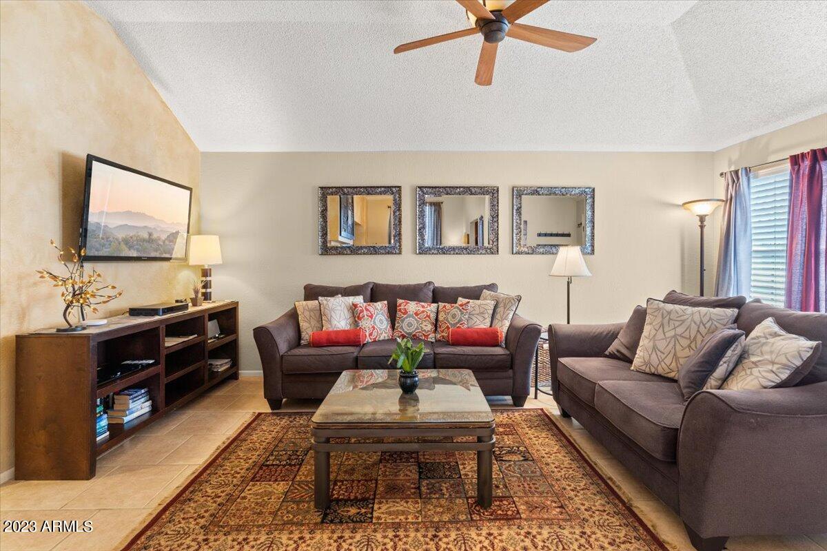 10017 East Mountain View Road, Unit 2053 Scottsdale, AZ 85258 - Photo 11 of 31 a living room with furniture and a flat screen tv