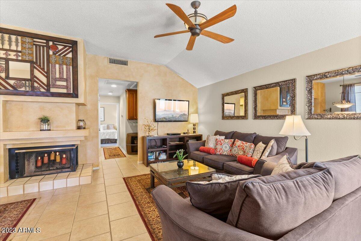 10017 East Mountain View Road, Unit 2053 Scottsdale, AZ 85258 - Photo 12 of 31 a living room with furniture and a fireplace