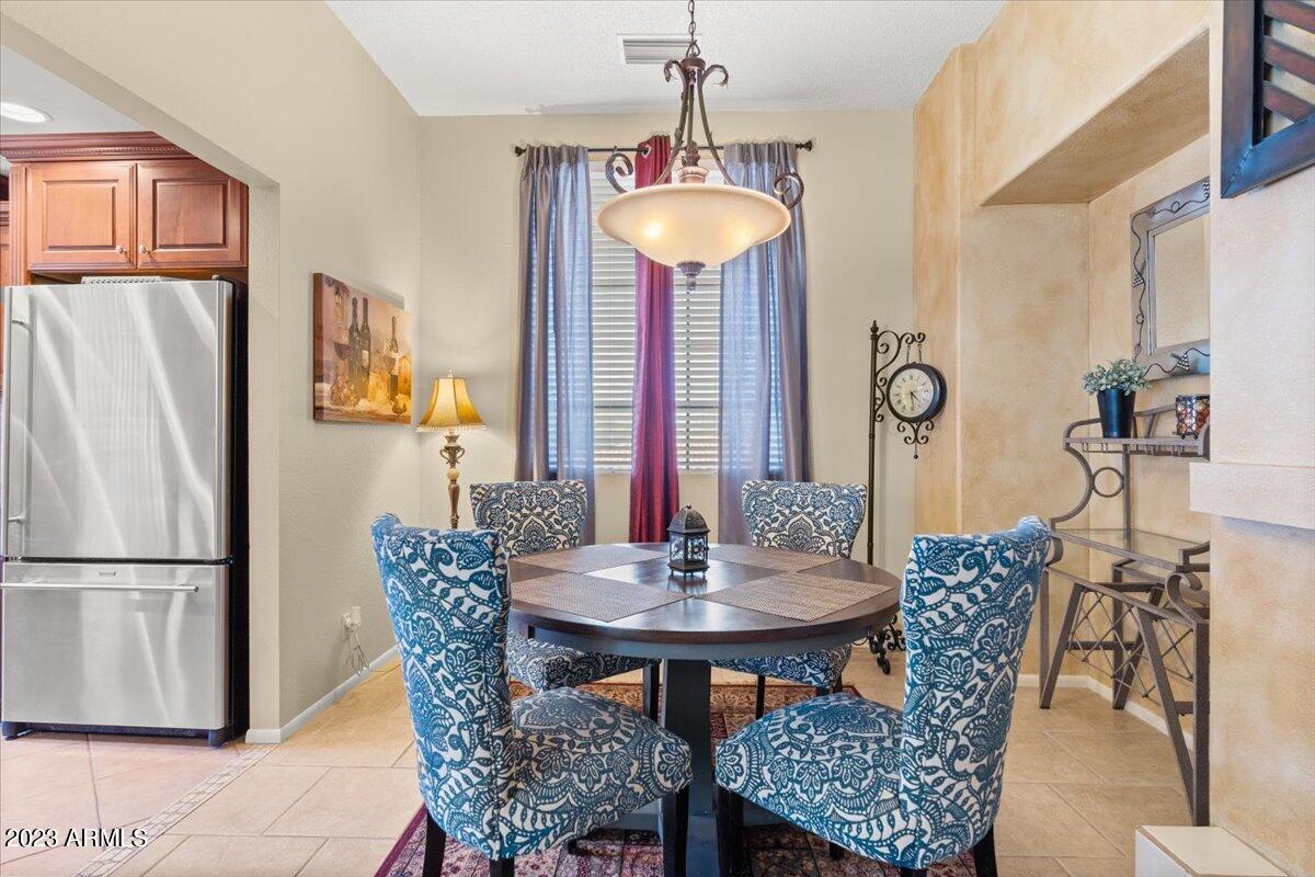 10017 East Mountain View Road, Unit 2053 Scottsdale, AZ 85258 - Photo 13 of 31 a view of a dining room with furniture and a chandelier