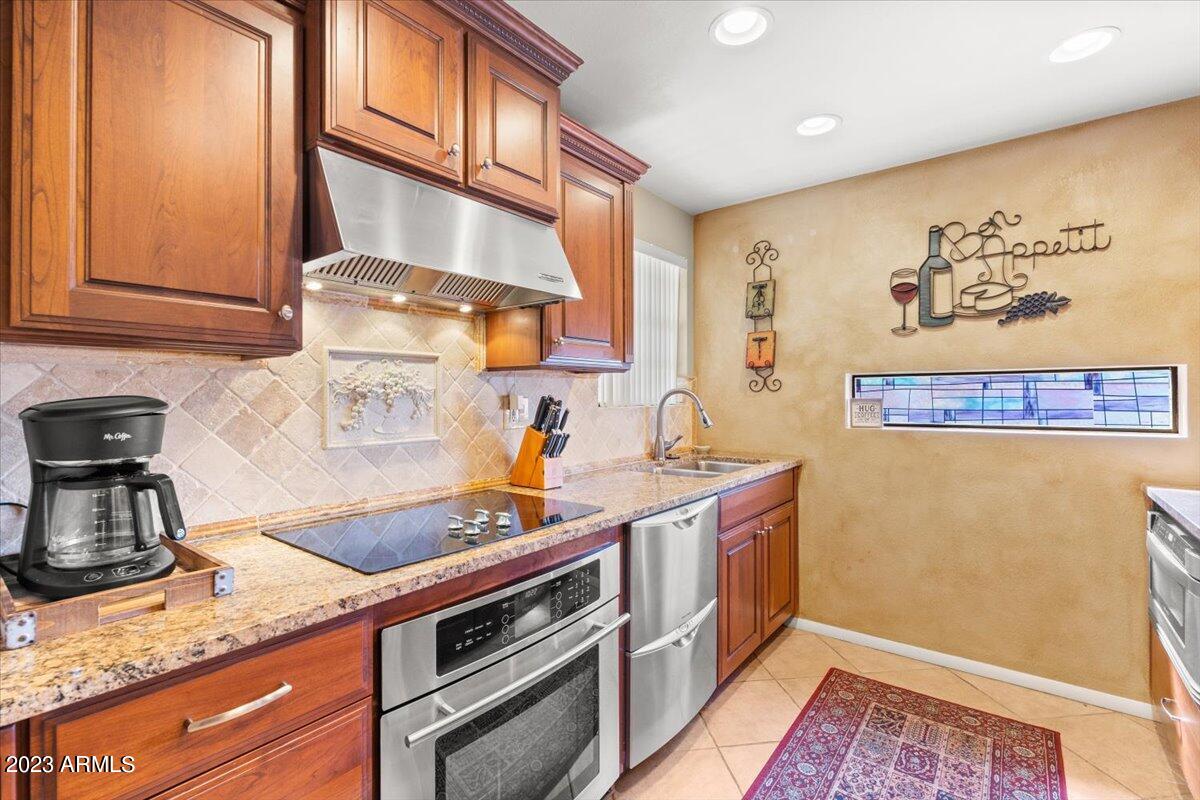 10017 East Mountain View Road, Unit 2053 Scottsdale, AZ 85258 - Photo 15 of 31 a kitchen with stainless steel appliances granite countertop a sink and cabinets