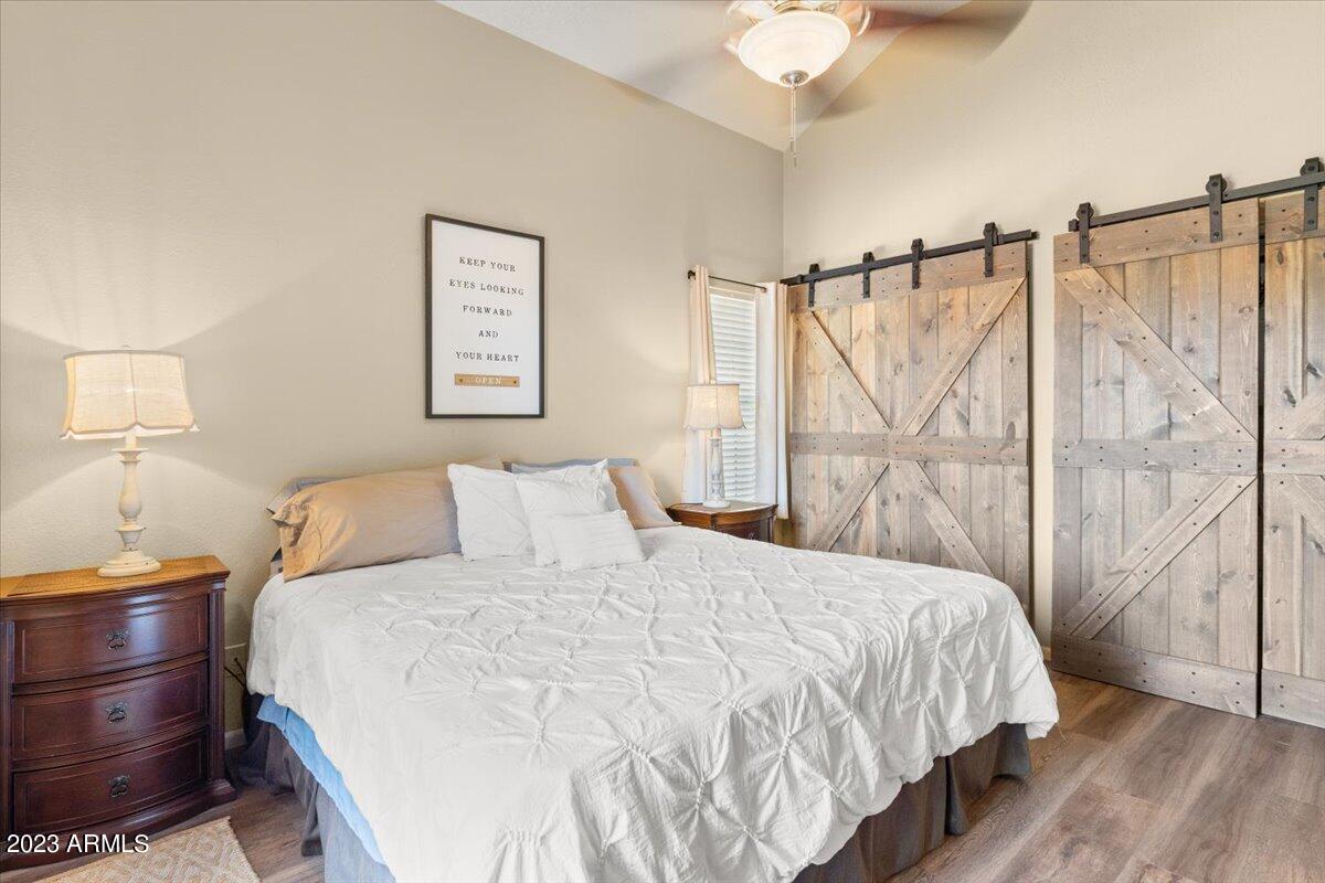 10017 East Mountain View Road, Unit 2053 Scottsdale, AZ 85258 - Photo 19 of 31 a bedroom with a bed and wooden floor