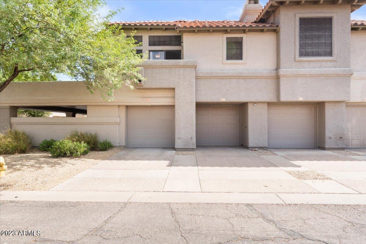10017 East Mountain View Road, Unit 2053 Scottsdale, AZ 85258 - Photo 31 of 31 a front view of a house with a yard and garage