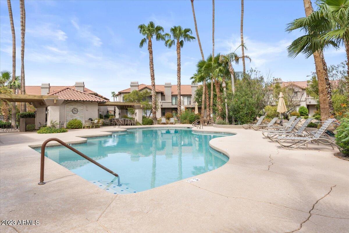 10017 East Mountain View Road, Unit 2053 Scottsdale, AZ 85258 - Photo 6 of 31 a view of swimming pool with a table and chairs