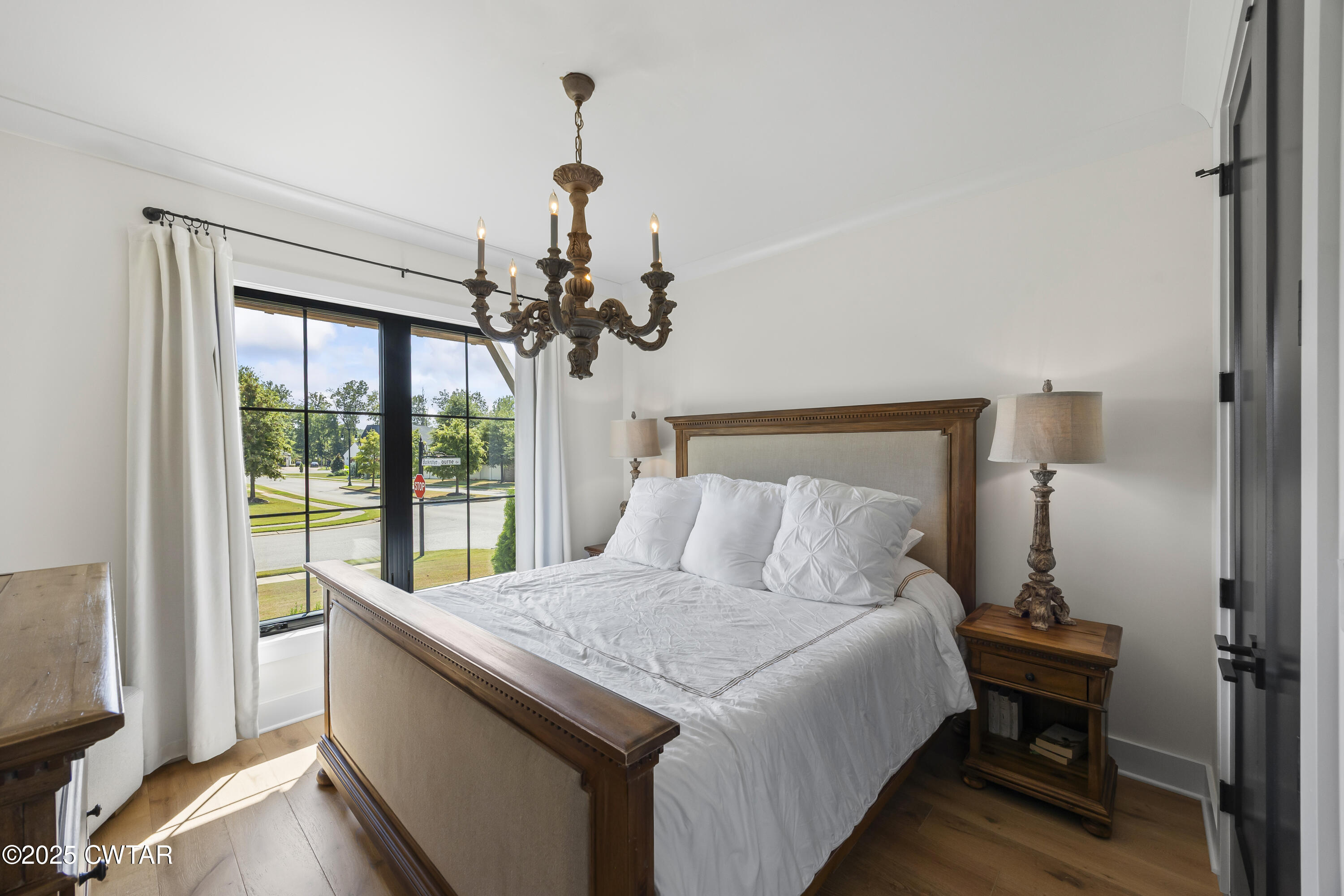 7 Swanbourne Cove Jackson, TN 38305 - Photo 22 of 44 a bedroom with a large bed and a chandelier