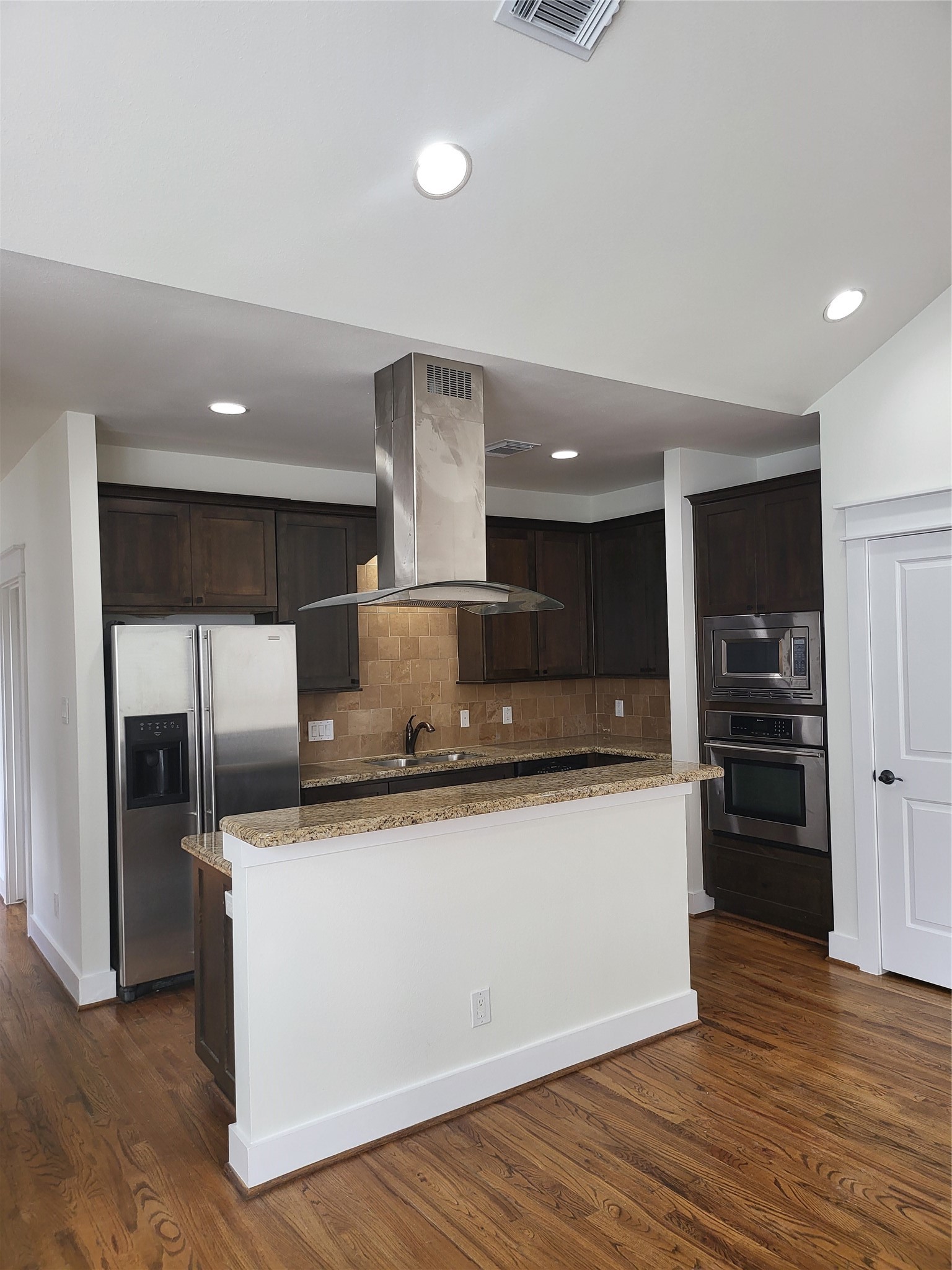 2423 Roufa Road Houston, TX 77003 - Photo 19 of 22 Kitchen with refrigerator, stove top, dishwasher, and built-in oven and microwave.