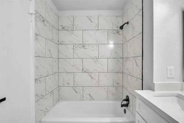 a bathroom with a bathtub and a sink