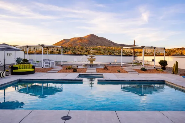 a view of a swimming pool with lounge chairs