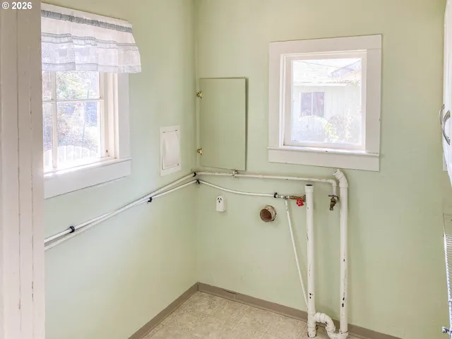a view of a hallway with wooden floor and entryway