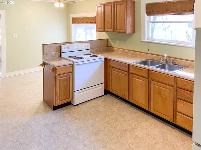 a kitchen with sink cabinets and window