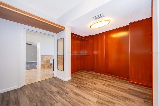 a view of an empty room with wooden floor