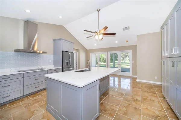 a view of a room with window and a ceiling fan in front of gate