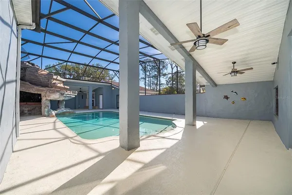 an aerial view of residential houses with swimming pool and outdoor space