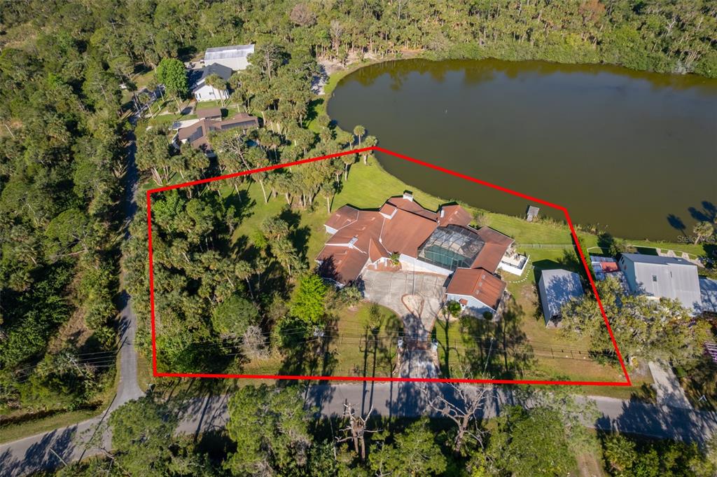 372 Rest Haven Road Geneva, FL 32732 - Photo 6 of 68 an aerial view of a house with a yard and lake view