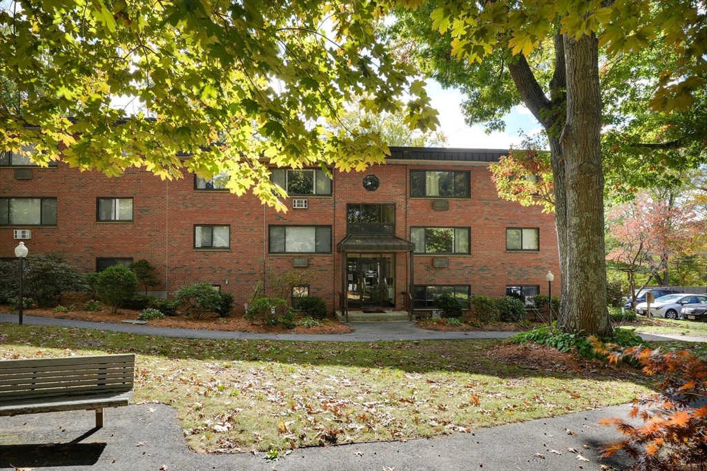 1323 Worcester Road, Unit 1E Framingham, MA 01701 - Photo 3 of 17 a front view of a house with garden