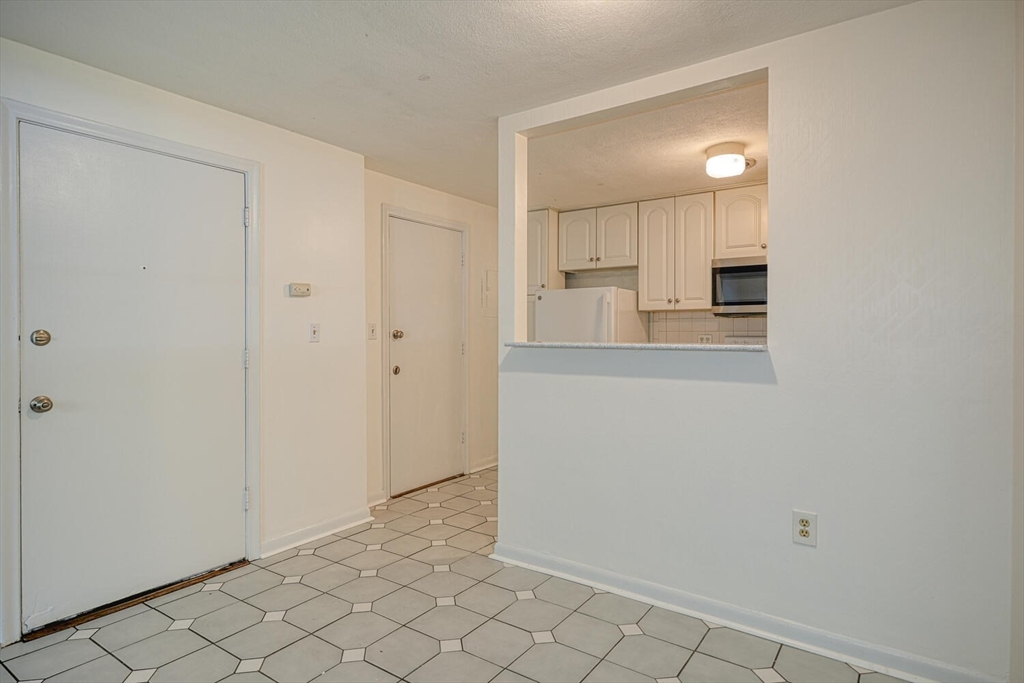 1323 Worcester Road, Unit 1E Framingham, MA 01701 - Photo 6 of 17 a view of a kitchen with white cabinets