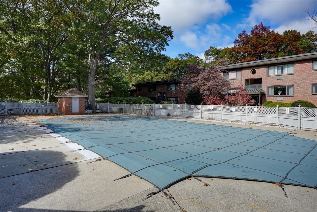 1323 Worcester Road, Unit 1E Framingham, MA 01701 - Photo 8 of 17 a swimming pool with outdoor seating and yard