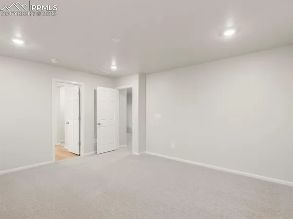 a spacious bathroom with a double vanity sink mirror and shower
