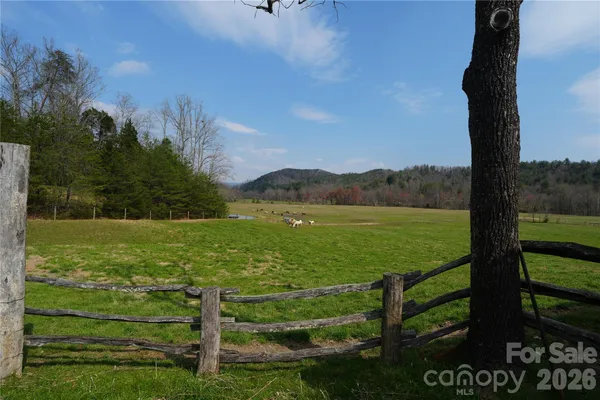 a view of a field with an ocean view