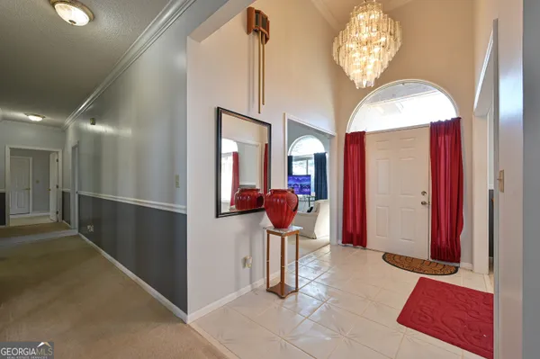 a view of a dining room with furniture and chandelier