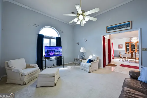 a living room with furniture and a chandelier