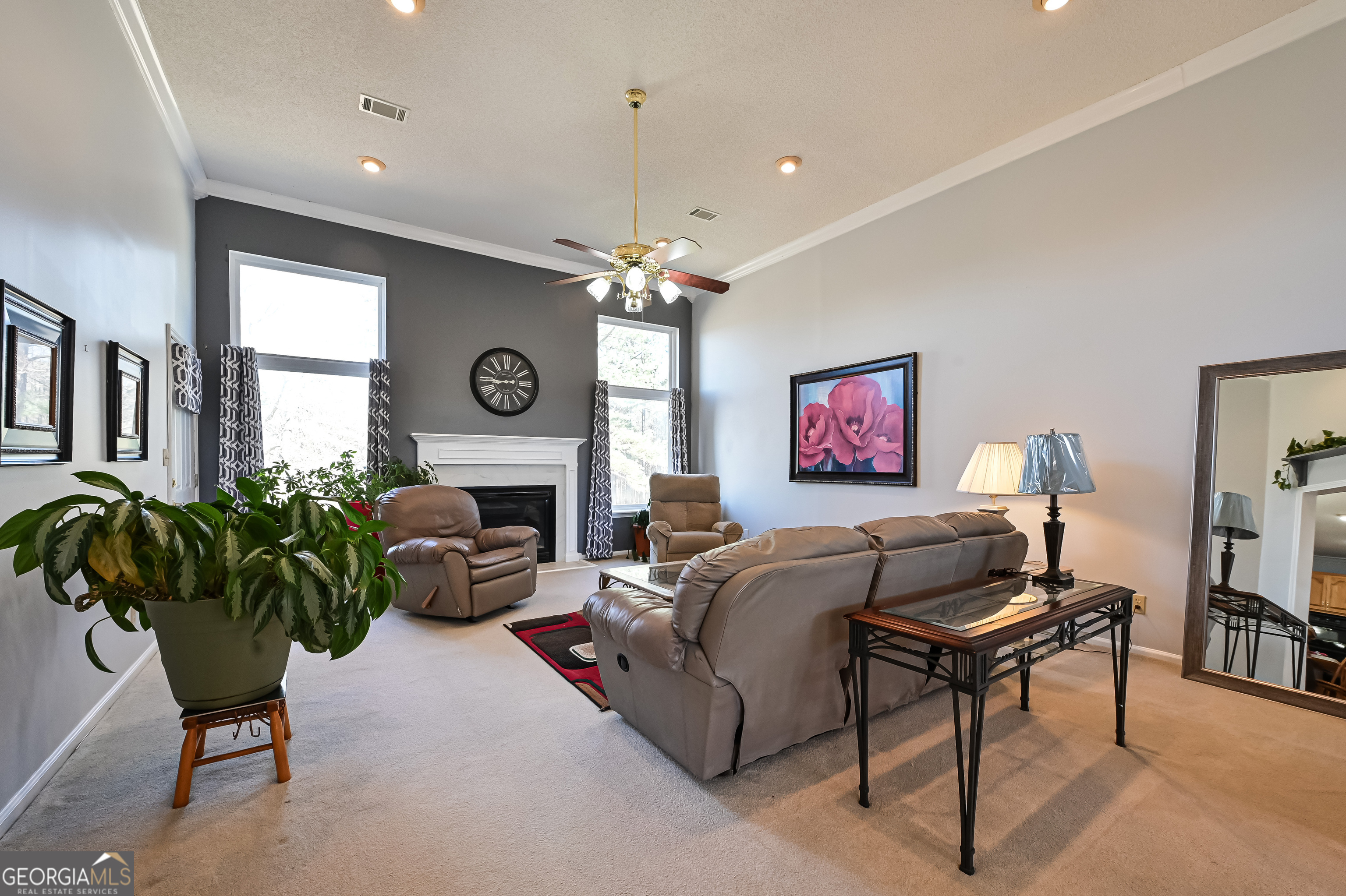 5152 Sandy Bottom Road Blakely, GA 39823 - Photo 19 of 40 a living room with furniture a fireplace and a chandelier