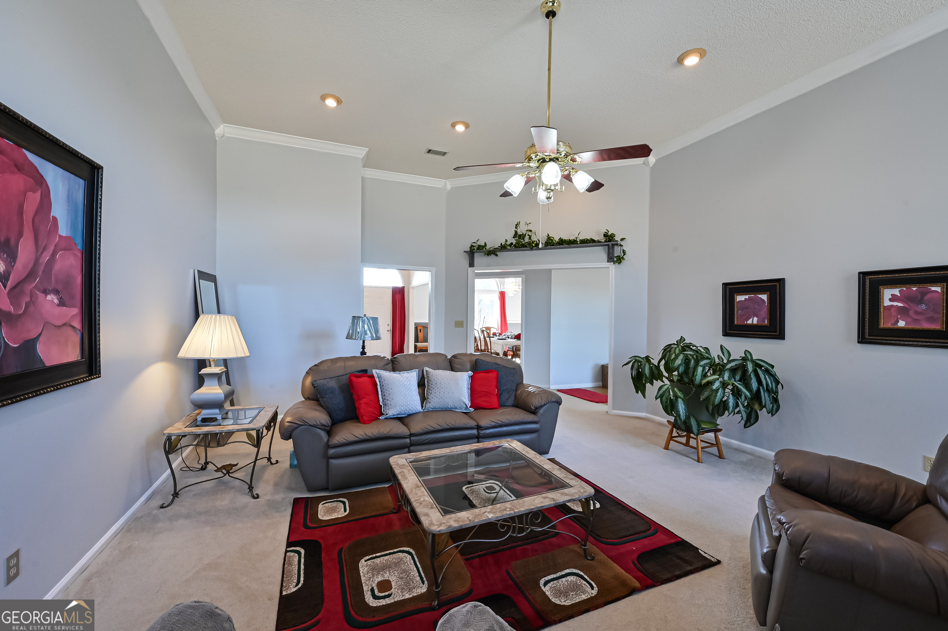 5152 Sandy Bottom Road Blakely, GA 39823 - Photo 21 of 40 a living room with furniture a chandelier and a flat screen tv
