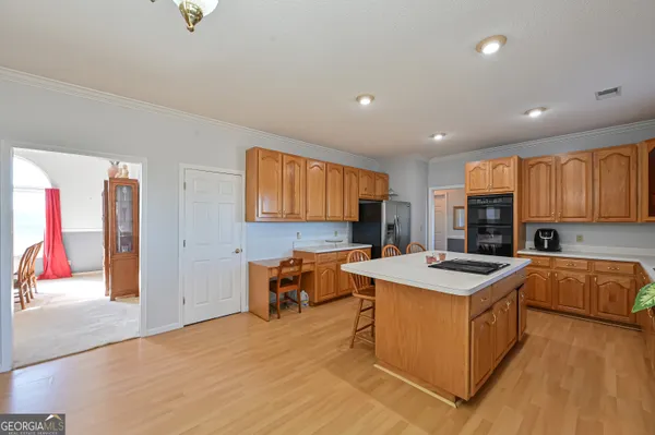 a kitchen with a sink a stove and chairs