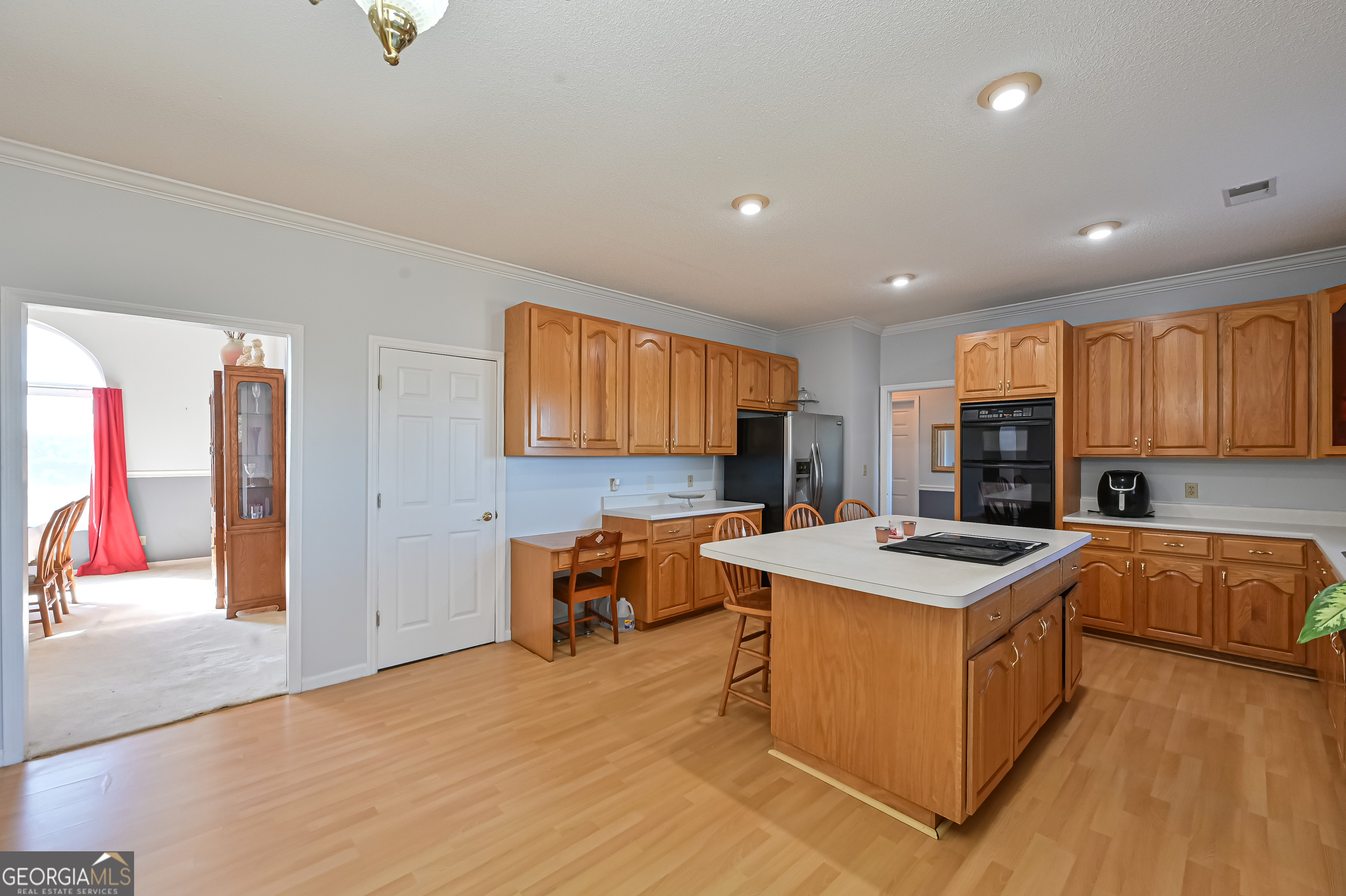 5152 Sandy Bottom Road Blakely, GA 39823 - Photo 24 of 40 a kitchen with stainless steel appliances granite countertop a stove top oven a sink dishwasher and a refrigerator with wooden floor