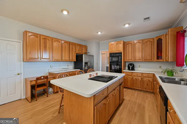 a kitchen with stainless steel appliances a sink stove and cabinets