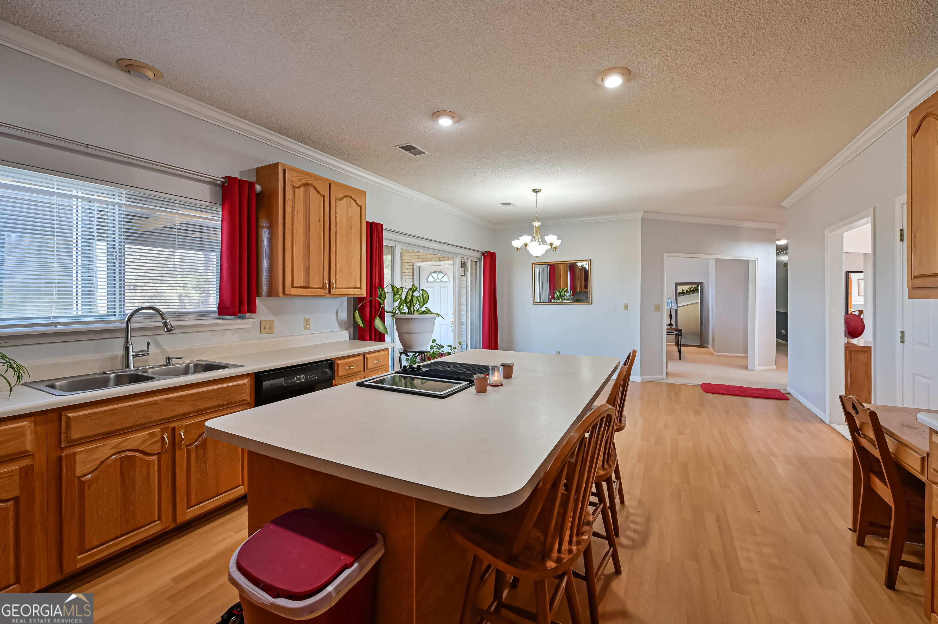 5152 Sandy Bottom Road Blakely, GA 39823 - Photo 26 of 40 a kitchen with a sink a stove and chairs