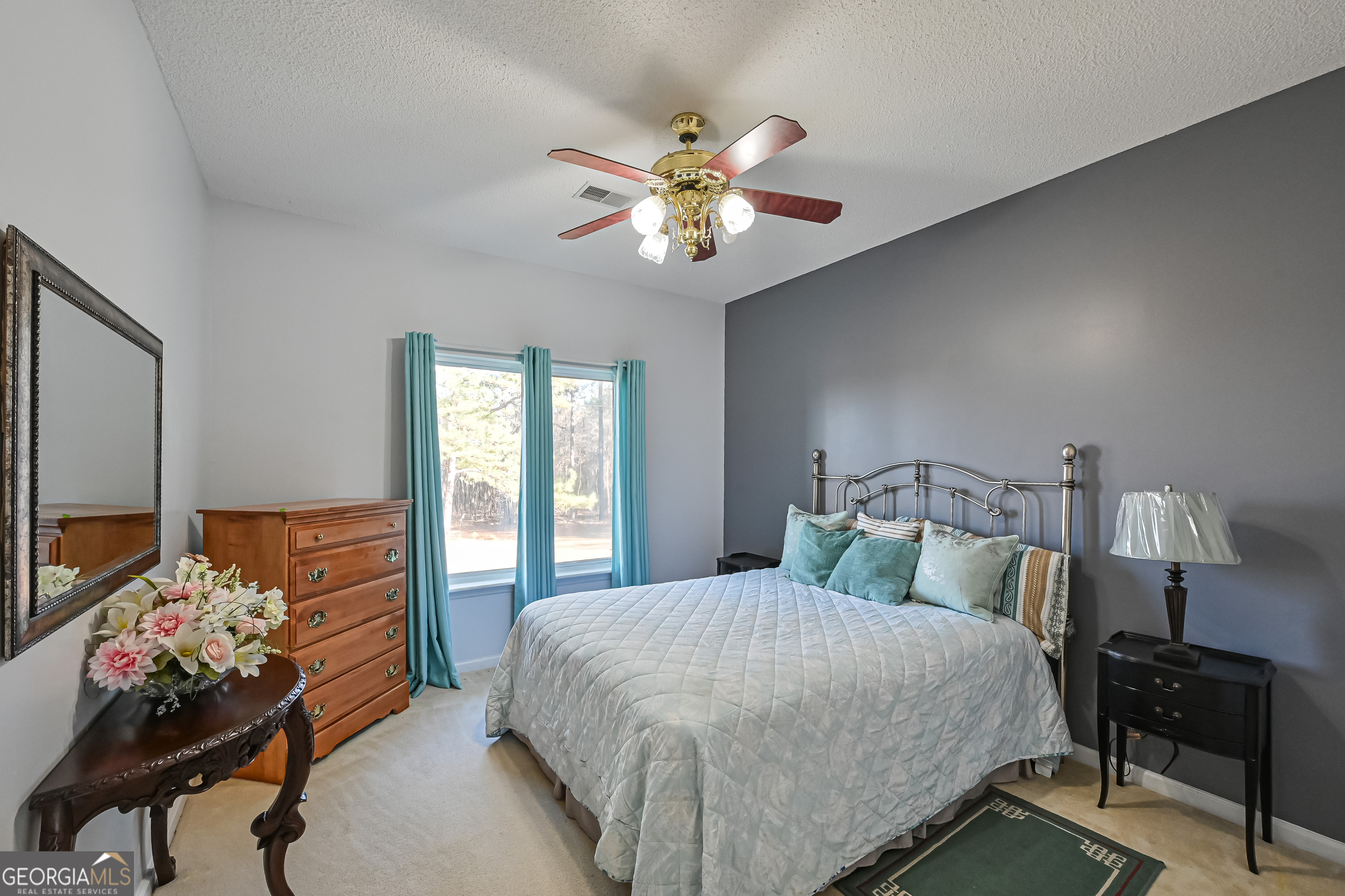 5152 Sandy Bottom Road Blakely, GA 39823 - Photo 31 of 40 a bedroom with a bed and a chandelier