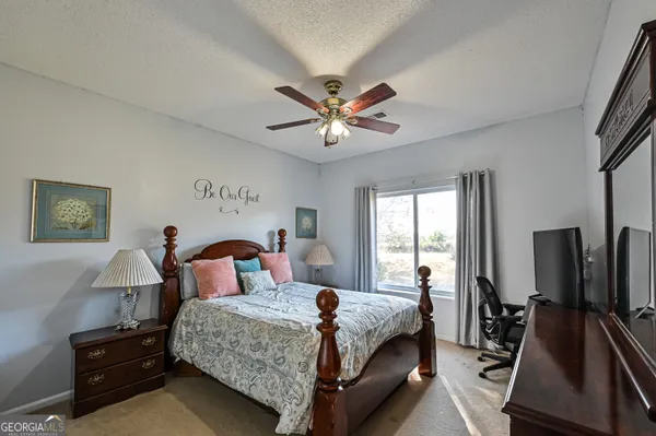 a bedroom with furniture and a dresser