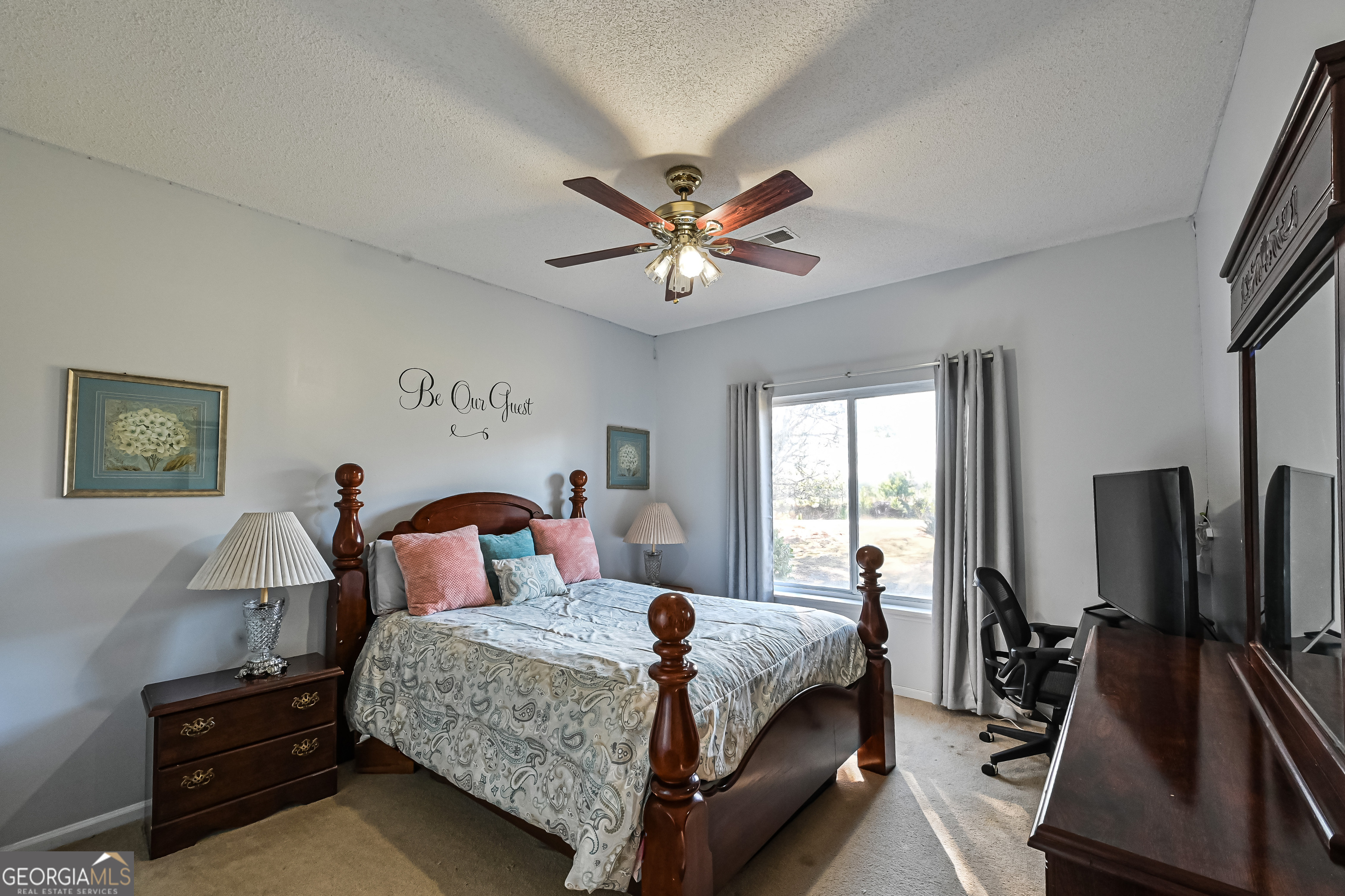 5152 Sandy Bottom Road Blakely, GA 39823 - Photo 32 of 40 a bedroom with a bed and a chandelier