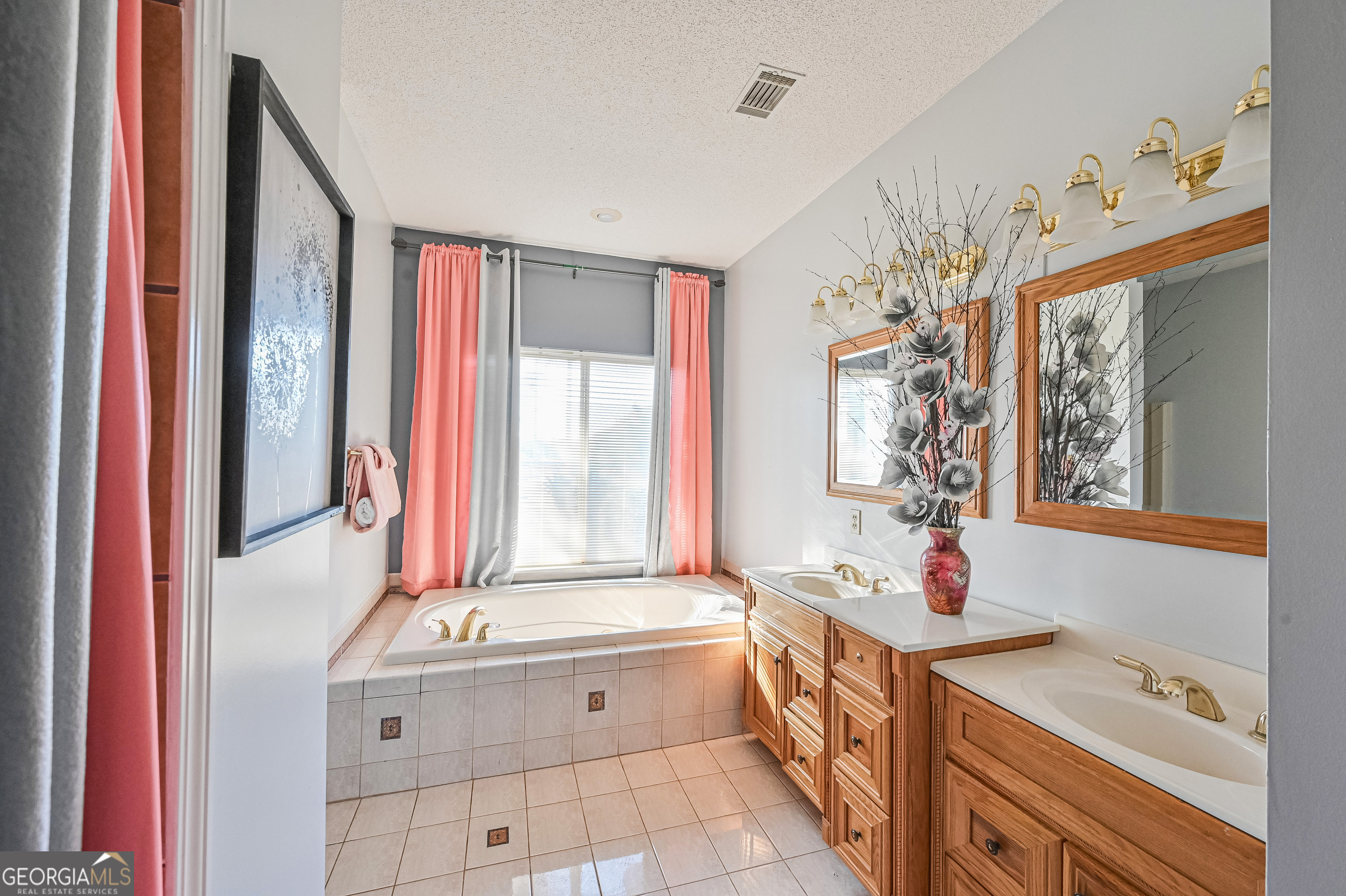 5152 Sandy Bottom Road Blakely, GA 39823 - Photo 36 of 40 a spacious bathroom with a tub sink and mirror