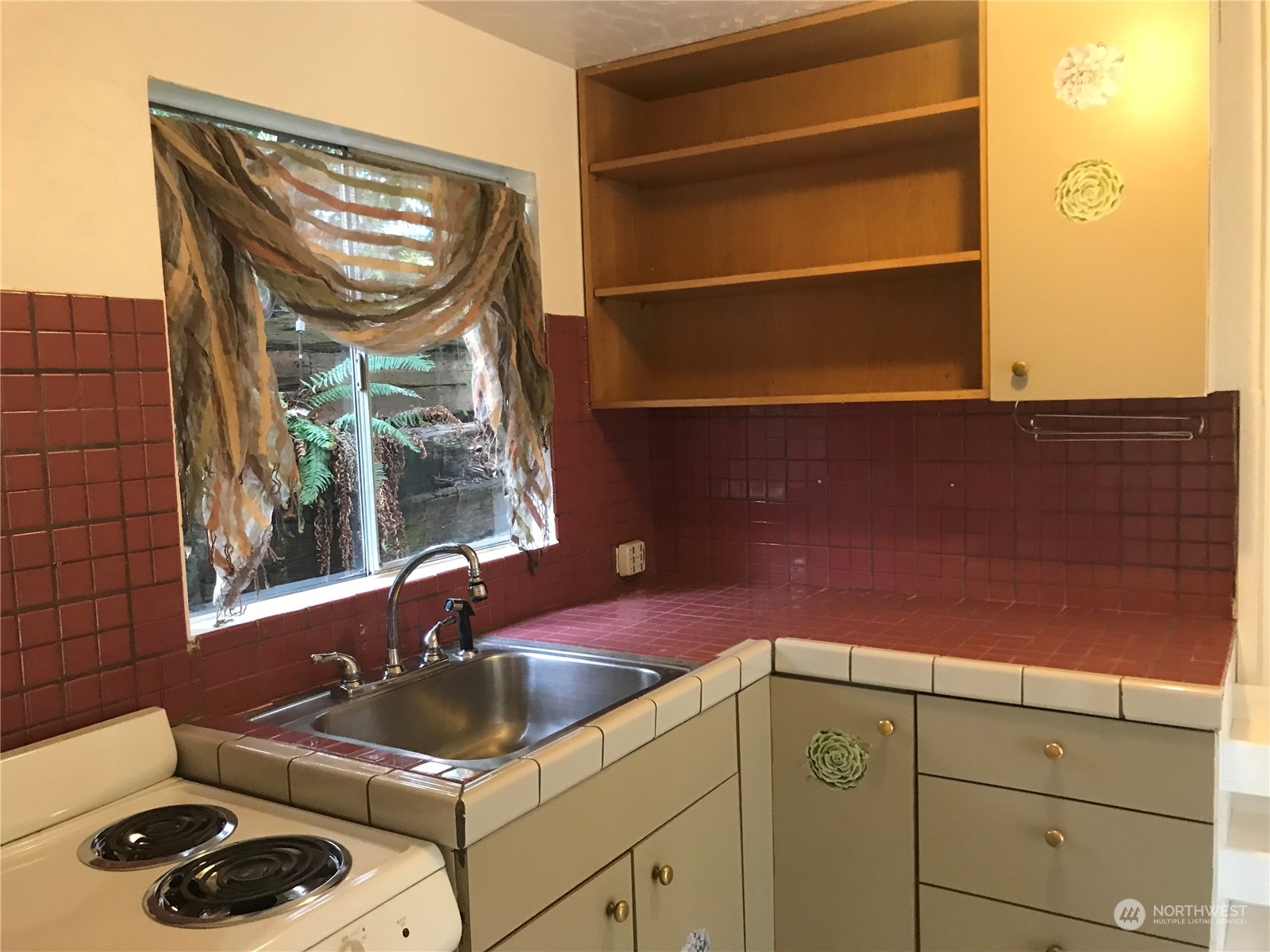 3843 22nd Avenue Southwest Seattle, WA 98106 - Photo 18 of 21 a kitchen with a sink and cabinets