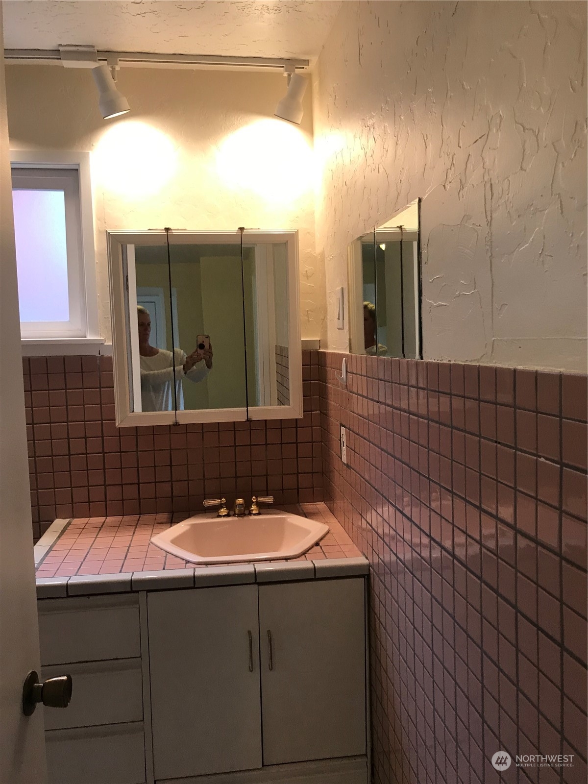 3843 22nd Avenue Southwest Seattle, WA 98106 - Photo 19 of 21 a bathroom with a sink and a mirror