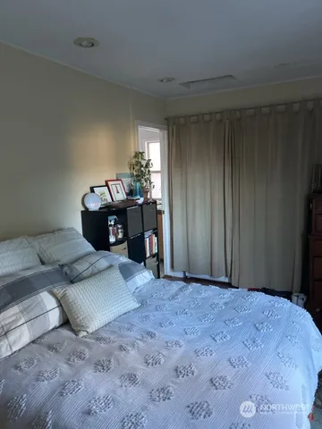 a bedroom with a bed and window