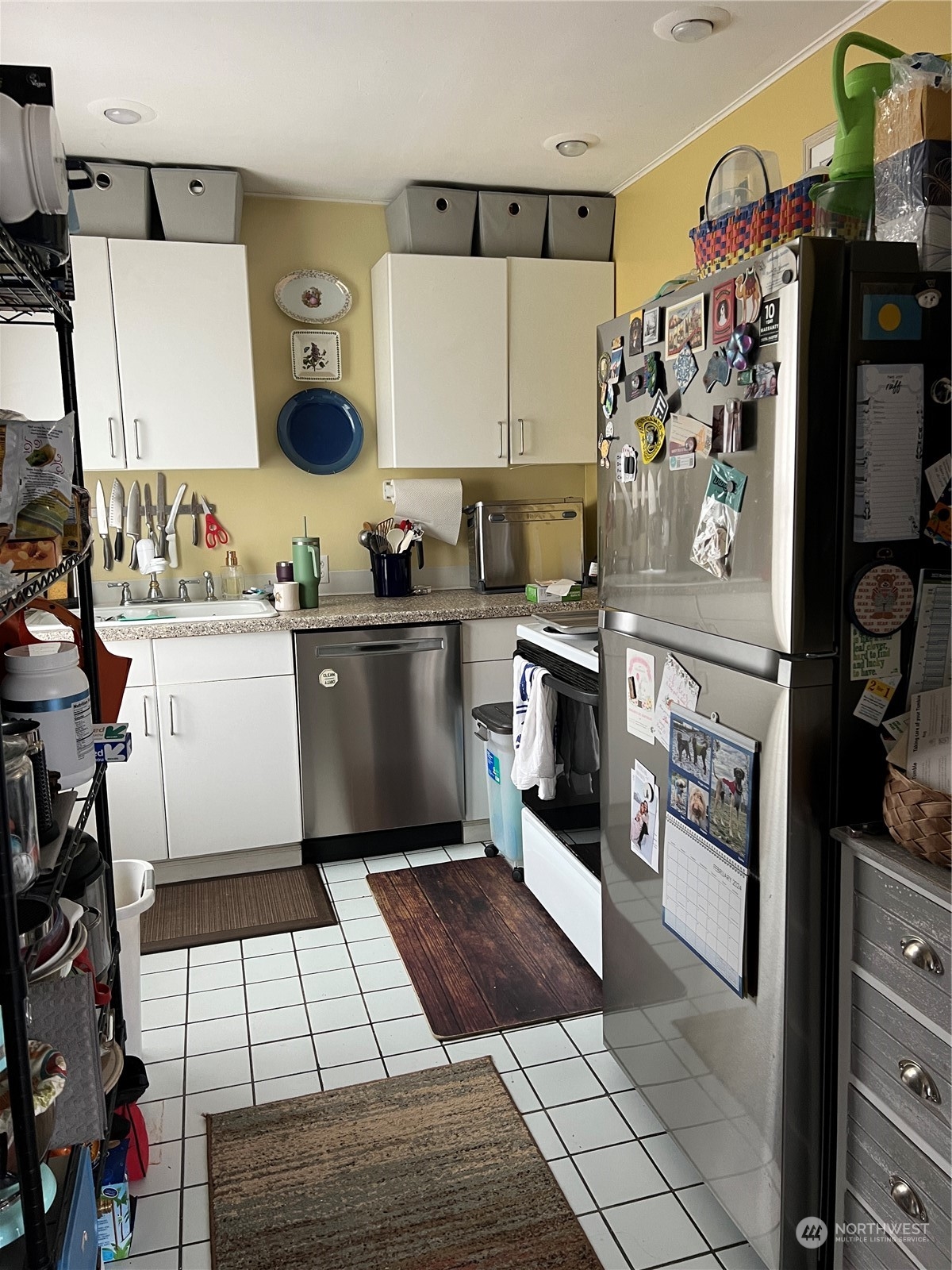 3843 22nd Avenue Southwest Seattle, WA 98106 - Photo 7 of 21 a kitchen with stainless steel appliances granite countertop a stove and a refrigerator