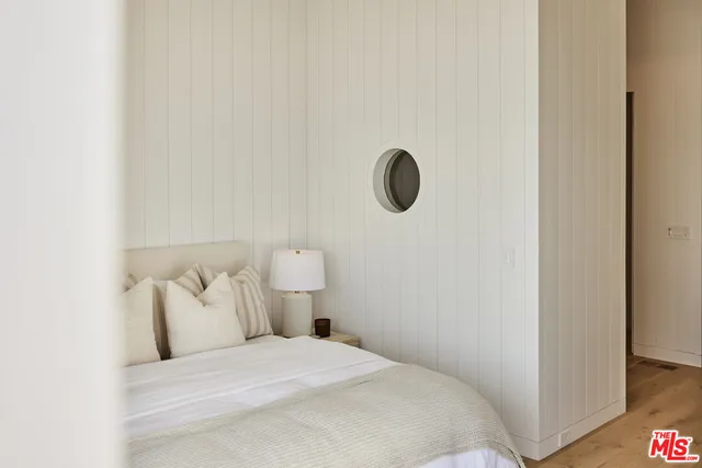 a view of roof deck with chair and wooden floor