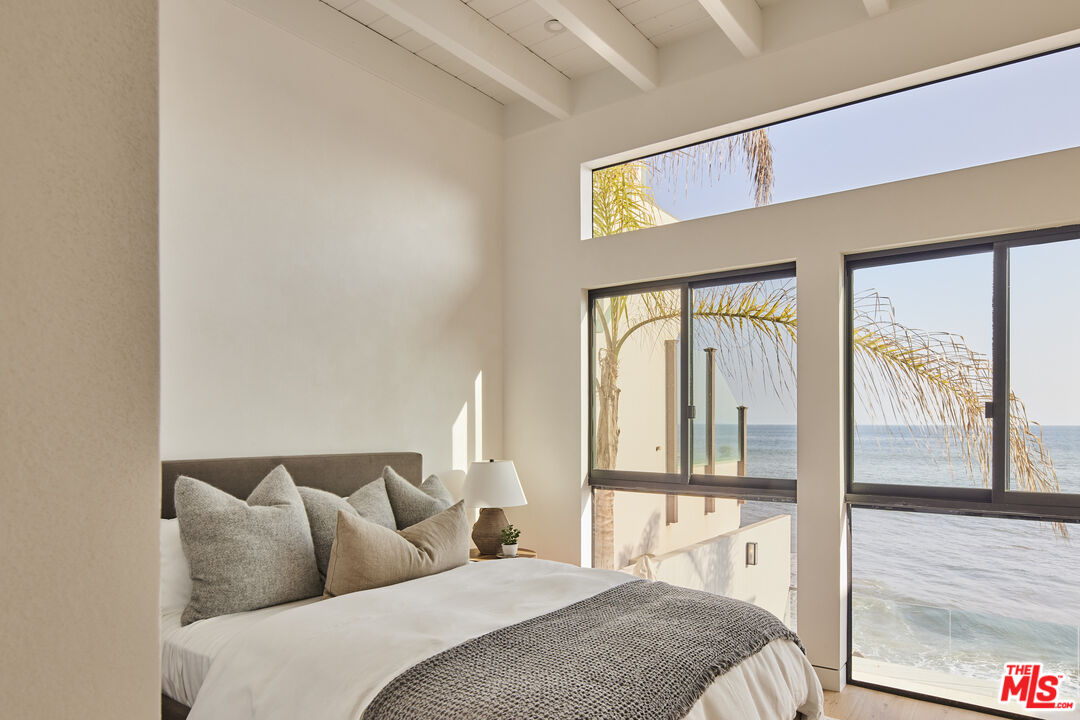 27356 Escondido Beach Road Malibu, CA 90265 - Photo 14 of 17 a bedroom with a large bed and a large window