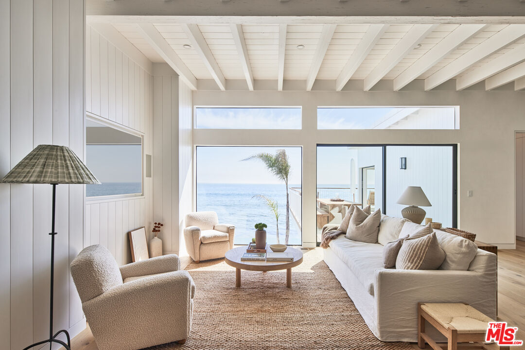 27356 Escondido Beach Road Malibu, CA 90265 - Photo 2 of 17 a living room with furniture and a large window with garden view