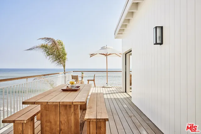 a bedroom with a bed and a large window with outer view
