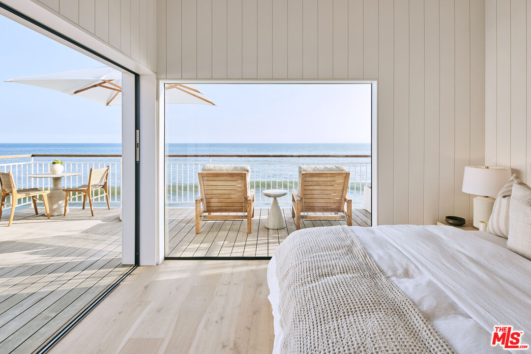 27356 Escondido Beach Road Malibu, CA 90265 - Photo 10 of 17 a bedroom with a bed and a large window with outer view